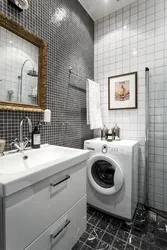 Interior of a small bath with sink and washing machine