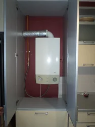 Kitchen design with gas boiler and pipes photo