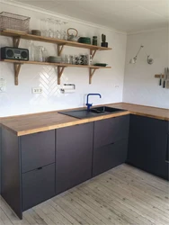 Black kitchen design without upper cabinets