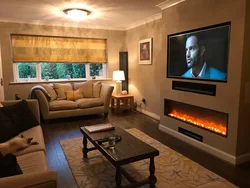 Photo of a living room with a fireplace and TV in an apartment