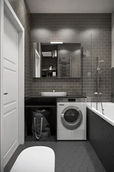 Bathroom interior with toilet and small washing machine