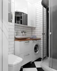 Bathroom interior with toilet and small washing machine