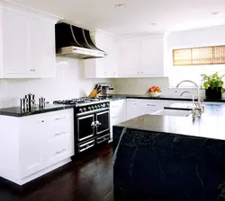 White glossy kitchen with black countertop photo
