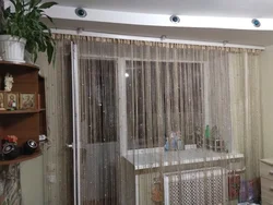 Thread curtains in the living room interior