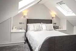 Bedroom interior in a house with a sloping ceiling