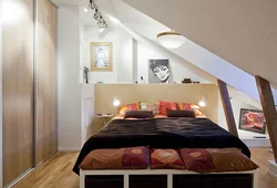 Bedroom interior in a house with a sloping ceiling