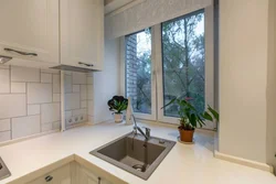 Kitchen design photo with sink by the window photo