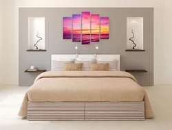 Paintings on the wall in the bedroom above the bed photo