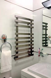 Heated towel rail in the bathroom photo