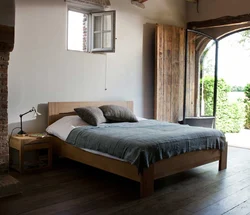 Wooden bed in the bedroom interior photo