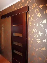 Wallpaper in the hallway with dark doors photo apartment