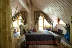 Bedroom design with a sloping ceiling in a wooden house