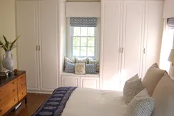 Bedroom design with wardrobe around window