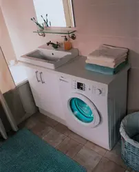 Washing machine under the sink in a small bathroom photo