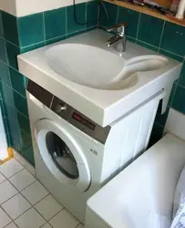 Washing machine under the sink in a small bathroom photo