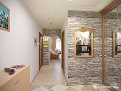 Decorative stone in the interior with hallway wallpaper