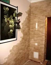 Decorative stone in the interior with hallway wallpaper