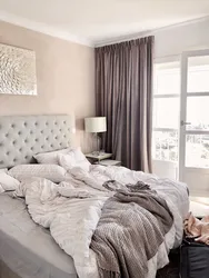 Beige bed in a gray bedroom photo