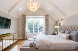Bedroom in the attic with a sloping ceiling photo