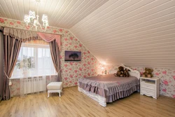 Bedroom in the attic with a sloping ceiling photo