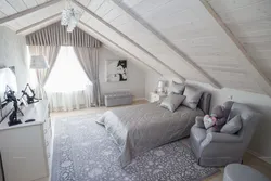 Bedroom In The Attic With A Sloping Ceiling Photo