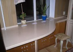 Countertop together with a window sill in the kitchen photo