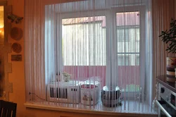 Thread curtains for the kitchen in the interior real photos
