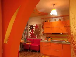 Orange kitchen in the interior photo with what kind of wallpaper and curtains