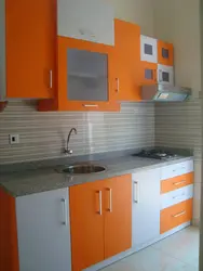 Orange kitchen in the interior photo with what kind of wallpaper and curtains