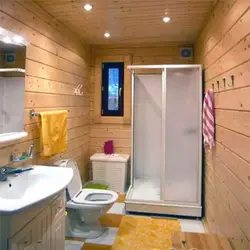Design of a bath with toilet and shower in a wooden house