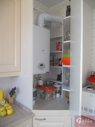Photo of a kitchen in a house with a boiler on the wall