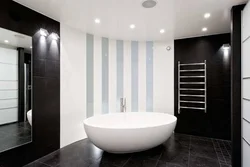 Bath with black floor and white walls photo