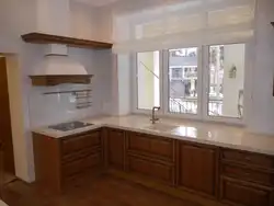 Corner kitchen design with sink by the window