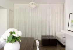 Milky curtains in the living room interior