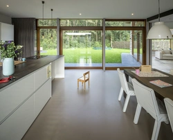 Kitchen design with a window and access to the terrace photo