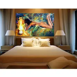 What kind of paintings are hung in the bedroom above the bed photo