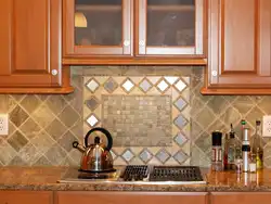 Laying tiles on a kitchen backsplash photo