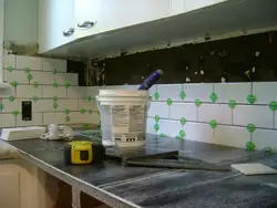 Laying Tiles On A Kitchen Backsplash Photo