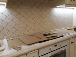 Laying Tiles On A Kitchen Backsplash Photo