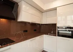 Beige kitchen design with black countertop