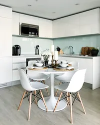 White chairs and table in the kitchen interior