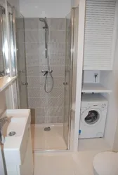 Showers and washing machines in a small bathroom photo