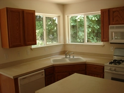 Photo of corner kitchens in a house with a window