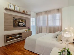 Wall design in the bedroom opposite the bed with TV