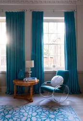 Turquoise color of curtains in the living room interior photo