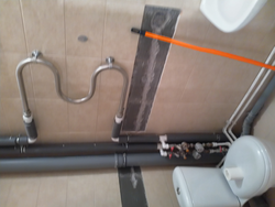 Photo of pipes on the bathroom wall