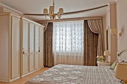 One curtain in the bedroom interior photo