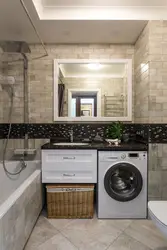 Photo of a bathroom countertop under the sink and washing machine