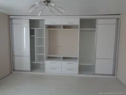 Photo of a wardrobe in the living room that covers the entire wall