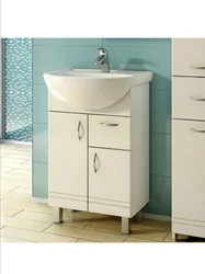 Washbasin in the bathroom with cabinet photo